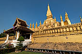 Vientiane, Laos - Surrounded by a cluster of pointed minor stupas the huge Pha That Luang shined under the warm light of the sunset.  